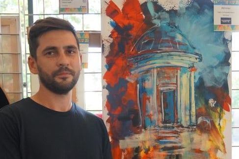 Lukasz Lepig pictured with his painting, which won him a Picturesque Highly Commended Award.