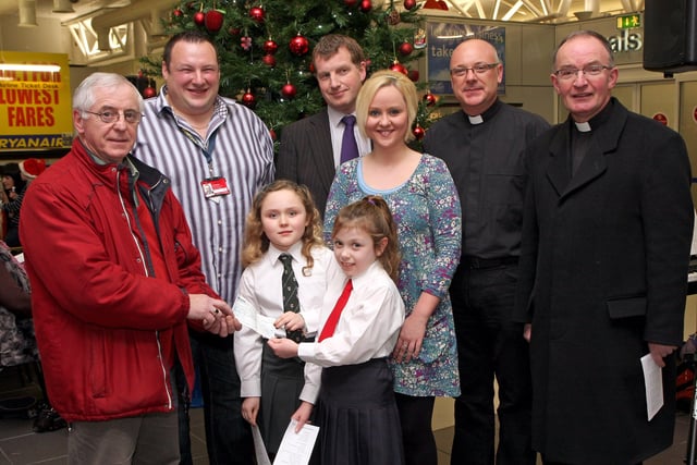 School pupils Aimee McKnight, Eglinton PS and Caoimh Barr, Broadbridge PS, present a cheque, proceeds from the City of Derry Airport annual Christmas Carol Service, to Peter Heaney, representing  Foyle Cruse Bereavement Care.  Included (from left), are Julian Benbow, City of Derry Airport, Rev. Lindsay Blair, Faughanvale Presbyterian Church, soloist Rachel Ewing, Rev. Brian Hasson, St.Canice Church of Ireland and Rev. Fr. Noel McDermott, Faughanvale parish.