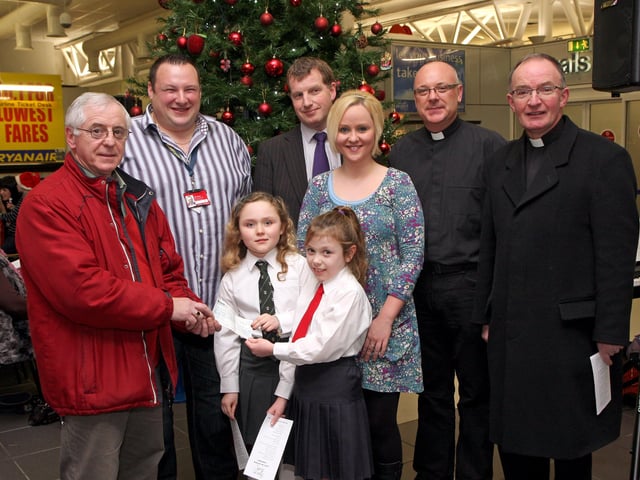 School pupils Aimee McKnight, Eglinton PS and Caoimh Barr, Broadbridge PS, present a cheque, proceeds from the City of Derry Airport annual Christmas Carol Service, to Peter Heaney, representing  Foyle Cruse Bereavement Care.  Included (from left), are Julian Benbow, City of Derry Airport, Rev. Lindsay Blair, Faughanvale Presbyterian Church, soloist Rachel Ewing, Rev. Brian Hasson, St.Canice Church of Ireland and Rev. Fr. Noel McDermott, Faughanvale parish.
