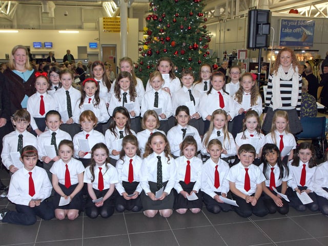 School choirs from Eglinton PS and Broadbridge PS, who took part in the City of Derry Airport annual Christmas carol service. Included are teachers (left), Alision Quigley and Hilary McKendry, and (right), Lorraine Cullen.