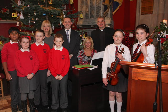 Rev. Malcolm Ferry, who conducted the Lisnagelvin Primary School’s annual Carol Service in All Saint’s Clooney Church, pictured with Joy Tennis, music teacher, Colin Torrens, principal, Janice Caldwell, pianist and members of the school choir and orchestra.  INLS 5211-508MT.