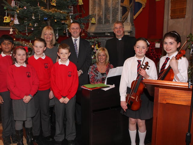 Rev. Malcolm Ferry, who conducted the Lisnagelvin Primary School’s annual Carol Service in All Saint’s Clooney Church, pictured with Joy Tennis, music teacher, Colin Torrens, principal, Janice Caldwell, pianist and members of the school choir and orchestra. INLS 5211-508MT.