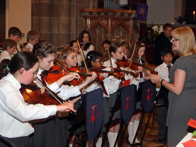 Music  teacher Joy Tennis, with the school orchestra, playing at the Lisnagelvin Primary School’s annual Carol Service in All Saint’s Clooney Church.  INLS 5211-509MT.