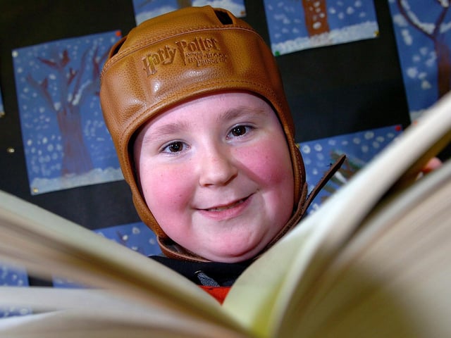 Maghera Primary School pupil Gavin engrossed in his Harry Potter book during the school's annual book fair in 2010.
