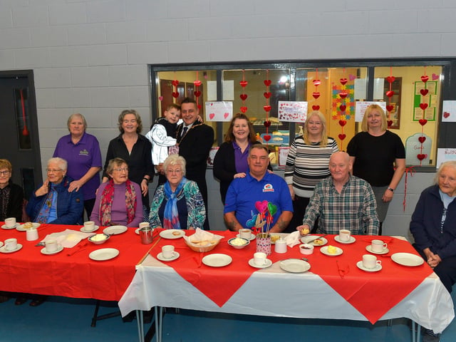 Mayor Alderman Graham Warke and his son Ollie pictured with members and volunteers of the Caw/Nelson Drive DEEDS group at the ‘Love-in-a-bucket’ Dementia Valentines Tea-Dance in Caw community Centre on Wednesday morning last. Photo: George Sweeney.  DER2207GS – 006
