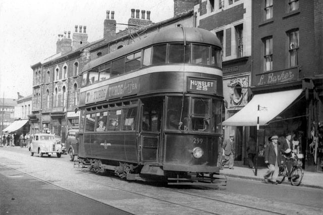 Tram no.299 travelling along Hunslet Road on route no.25 to Hunslet. Shops visible include to the right L. Barker, draper, then Hunslet sub-post office. Tram 299 was an ex-Southampton one acquired by Leeds in 1949.