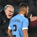 Uruguay's coach Argentine Marcelo Bielsa (L) gives instructions to Uruguay's defender Sebastian Caceres during the 2026 FIFA World Cup South American qualification football match between Uruguay and Brazil at the Centenario Stadium in Montevideo on October 17, 2023. (Photo by Eitan ABRAMOVICH / AFP) (Photo by EITAN ABRAMOVICH/AFP via Getty Images)