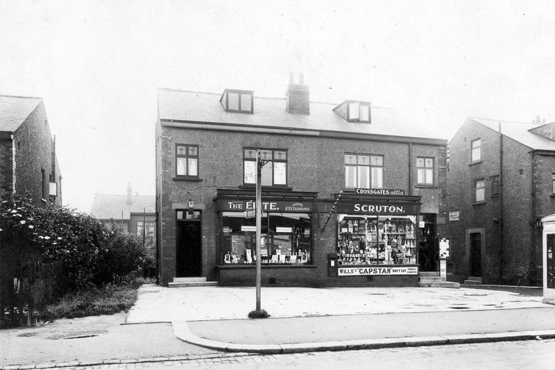 Two shops on Church Lane pictured in June 1935., The Elite, ladies and gents hairdressing and Cross Gates Post Office, with the name 'Scruton'. Goods can be seen in shop window.