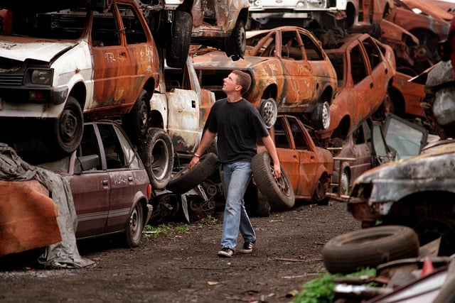 Recovery driver Mark Crisp is surrounded by the remains of stolen cars in the storage yard at Dragon Bridge Auto at Wortley.