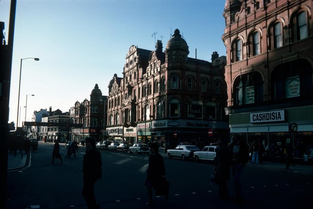 Looking south along Vicar Lane showing shops on the west side in January 1976. On the right is Cashdisia, ladies, mens and childrens wear, then after the junction with Queen Victoria Street are Peter Eastwood menswear, Wigfalls TV and electrical, Halfords cycle and car accessories and John Collier tailor. Next is the junction with King Edward Street then the Famous Army Stores. All of these are listed buildings.