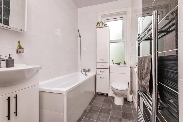 The family bathroom has a bath with shower overhead, low flush WC with useful storage underneath, wash hand basin and heated shower rail.