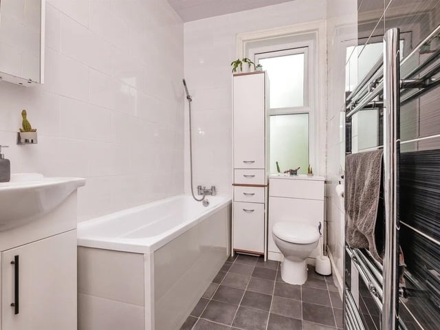 The family bathroom has a bath with shower overhead, low flush WC with useful storage underneath, wash hand basin and heated shower rail.