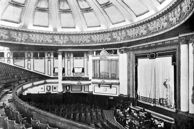 Inside the Majestic Cinema in City Square. The dome itself has a diameter of 84 feet, (nearly 26 metres) larger than the dome of St Paul's Cathedral in London. Even though a suspended ceiling now covers the circle area, the great frieze, depicting chariots and horsemen, surrounding the dome still remains. The image was taken in the year following the opening which took place on Whit Monday, June 5, 1922. The Grand £5,000 organ is also visible right of centre. The 1812 Overture was played on the organ by Harry Davidson, complete with special effects, at the opening of the cinema. The orchestra pit is seen beneath the curtains, bottom right. The Majestic Symphony Orchestra accompanied the silent films shown here in the early days.