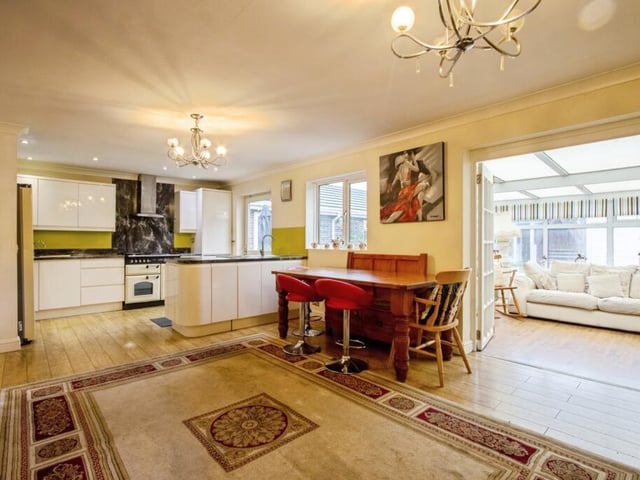 An open plan kitchen and diner leads through to the conservatory.