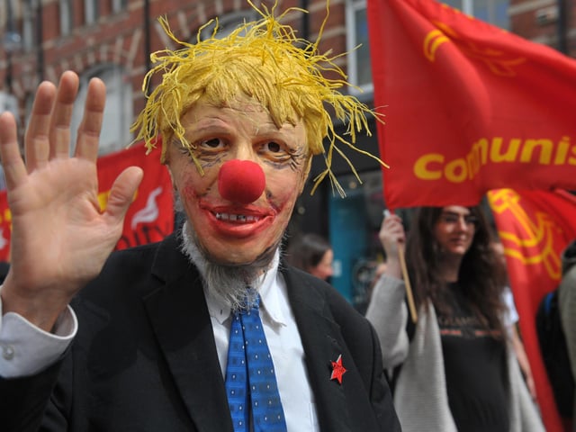 A campaigners wearing a Boris Johnson mask was amongst the many calling for improved pay.