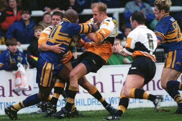 Rhinos guest player Wendell Sailor is tackled by Darren Rogers and Michael Eagar during Leeds' New Year's Day win over Castleford Tigers at Headingley in 1999. Picture by Bruce Rollinson.