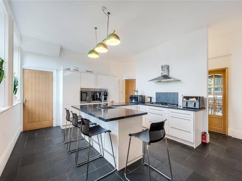 Positioned at the heart of the house, the kitchen combines generous proportions with a breakfast bar and seating, making it a natural space for everyday family life and informal gatherings.