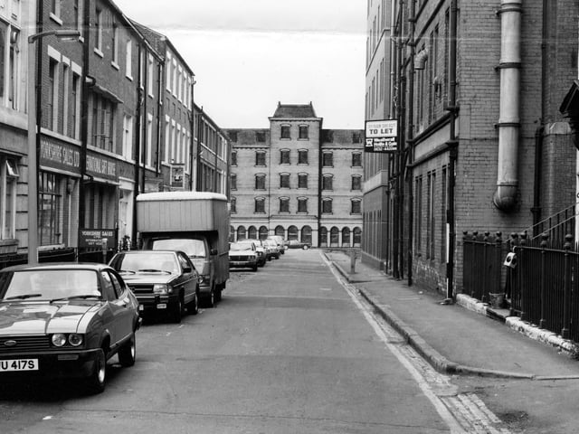 A view looking down York Place to Queen Street in July 1979. The buildings at the end, number 9 to 17 Queen Street, are an architect's drawing, a 'design to site'. It shows the redevelopment which includes a 5 storey office block toilets and an entrance lobby with 12 car parking spaces.