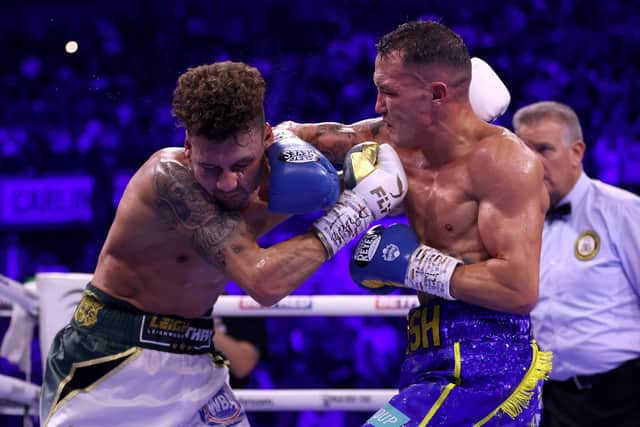 SHEFFIELD, ENGLAND - OCTOBER 07: Leigh Wood exchanges punches with Josh Warrington during the WBA World Featherweight Title fight between Leigh Wood and Josh Warrington at Utilita Arena Sheffield on October 07, 2023 in Sheffield, England. (Photo by James Chance/Getty Images)