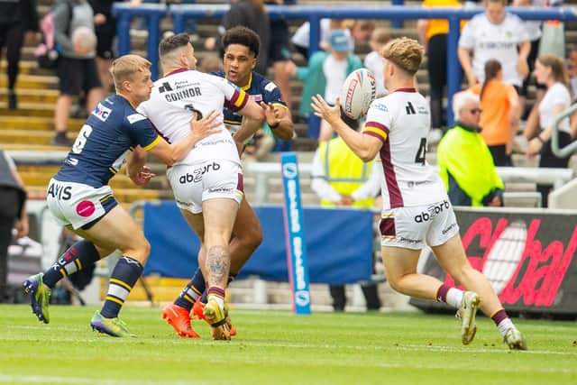 Alfie Edgell and Derrell Olpherts, seen tackling Jake Connor during a reserves game against Huddersfield, retain their place in Rhinos' initial squad, despite not featuring in the 17 last week. Picture by Craig Hawkhead/Leeds Rhinos.