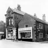 Lower Town Street showing the entrance to Patchett's Place, right. The two shop properties are, left, William Lax, Newsagent, at number 162 and right, Busy 'B' Ltd, Butchers, at number 160. Number 162 had been the location of Bramley Post Office since 1854. In 1892 Mr. J.W. Dawson took over the position of Post-master from his father and by the turn of the century it had become a thriving business. In 1902 600,000 letters were delivered and 7,000 telegrams and there was a turnover of £20,000. 8 postmen were making 3 daily deliveries in Bramley from this office. In the photograph parked in front of the Busy 'B' is the errand boy's bicycle with its large basket at the front for delivering the meat orders to homes within the community.