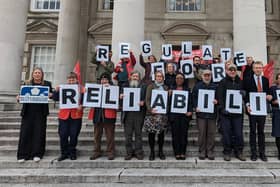 Standing outside Leeds Civic Hall campaigners and councillors held up giant letters to spell out the message “Regulate for Reliability”. Picture: BBFWY