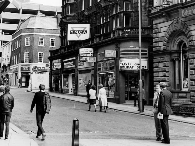 Shops on the east side of Albion Street in June 1984, showing, from right, Britannia Building Society, then the YMCA building with shops including Hunting Lambert travel agents, Raymond Appleson opticians and Bentley films photograhic equipment. Beyond the junction with Albion Place is Dacre Son and Hartley, estate agents. In the background on the left the multi-storey carpark over Schofields, now the Headrow Centre, can be seen.