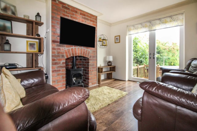 The first of two reception rooms, the cosy lounge features a wood-burning stove