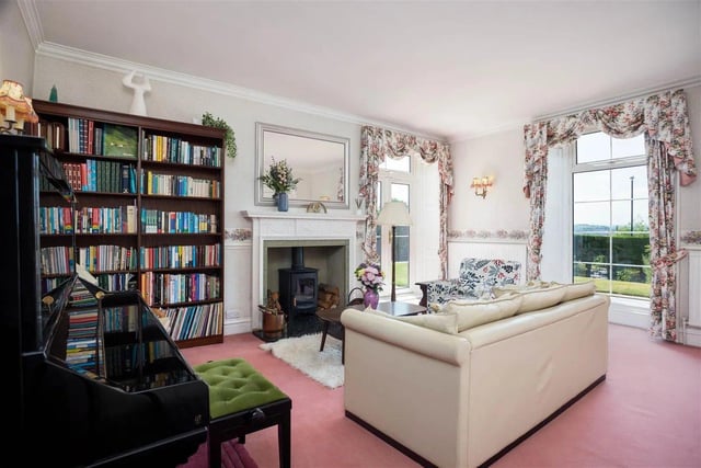 The ground floor has three large reception rooms, each with a beautiful fireplace.