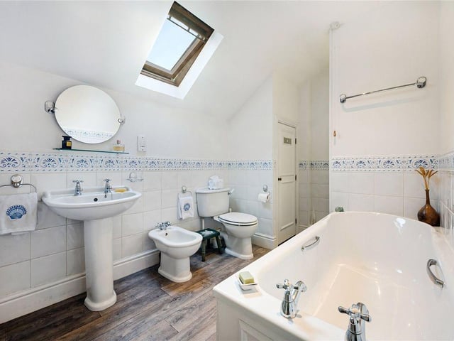 The property's main bathroom features a separate bath, shower and plenty of storage space.