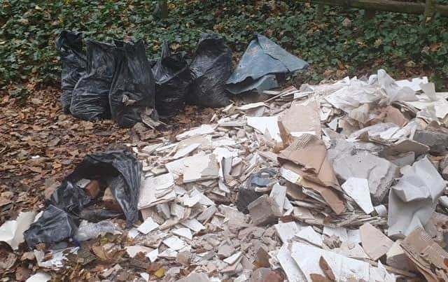 An investigation into a huge pile of bagged household waste, tiles and rubble found in a flytipping hotspot off Craig Lane in Alwoodley was launched by Leeds City Council’s new serious environmental crime team (SECT). Image: Leeds City Council
