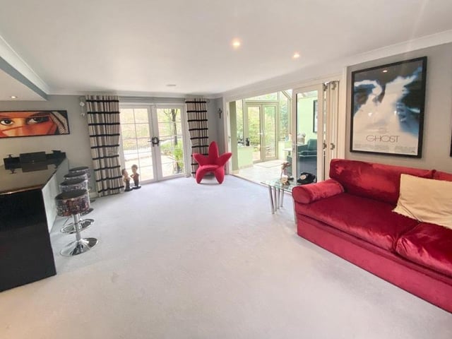 The sitting room with access to the patio seating area, and doors through to the orangery.