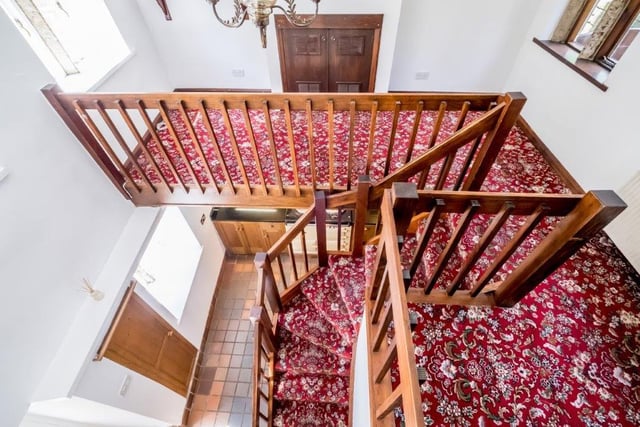 Looking down over the carpeted staircase to the hallway below.