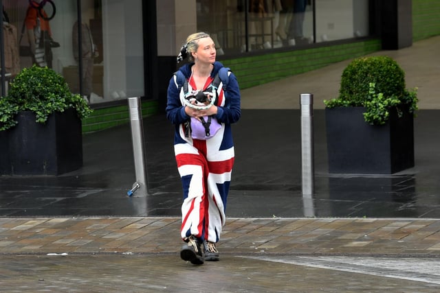 A lady sported a Union Jack onesie as she carried her dog through the city centre