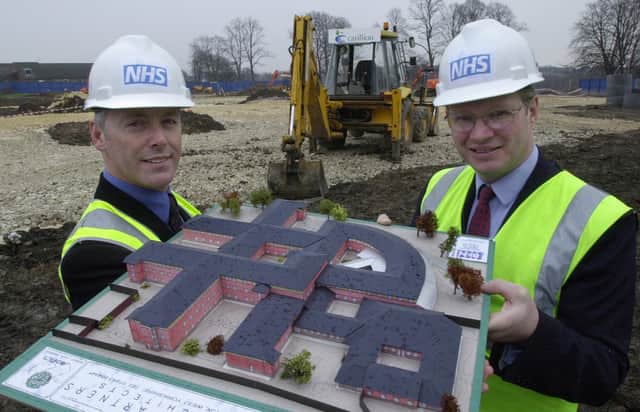 Mike Atkin, left, Chief Executive of Leeds Community and Mental Health Services Teaching NHS Trust and  Nigel Crisp, NHS chief Executive and Permanent Secretary for the Department of Health,  with a model of the new mental health services unit at Seacroft Hospital, in 2001.