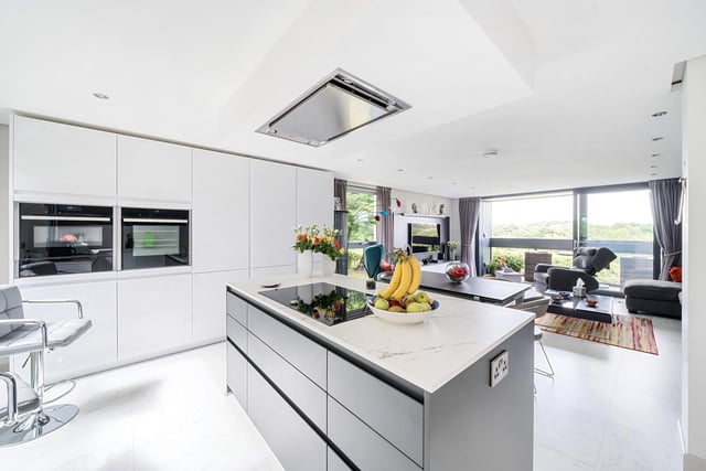 The kitchen area is fitted with an extensive range of storage with integrated Neff appliances and a Caple wine fridge.