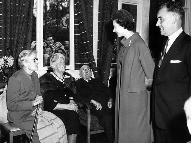 Her Majesty Queen Elizabeth II, accompanied by Councillor Albert King, Chairman of the Welfare Services Committee, is pictured talking to some of the residents of Brackenhurst Hostel in October 1958.