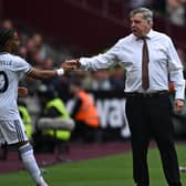 Leeds United's English head coach Sam Allardyce (R) shakes hands with Leeds United's Dutch striker Crysencio Summerville (L) as he prepares to come on as a substitute  (Photo by BEN STANSALL/AFP via Getty Images)