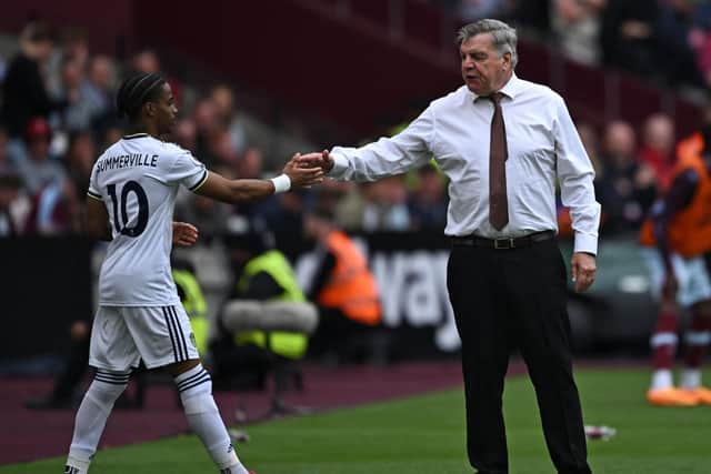 Leeds United's English head coach Sam Allardyce (R) shakes hands with Leeds United's Dutch striker Crysencio Summerville (L) as he prepares to come on as a substitute (Photo by BEN STANSALL/AFP via Getty Images)