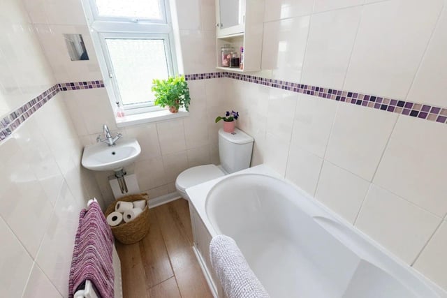 The bathroom comprises of a bath with shower over, hand basin and low level flush toilet.