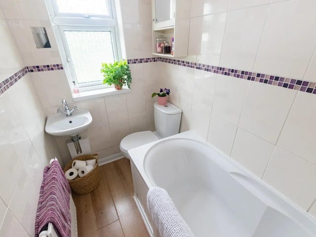 The bathroom comprises of a bath with shower over, hand basin and low level flush toilet.