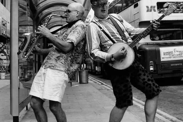 Buskers Moon de Lune took their two-man act on a bus-stop tour of Leeds, part of a 50-mile trip to nine different town centresm as a prelude to the Leeds Centenary Wind Festival in July 1993.