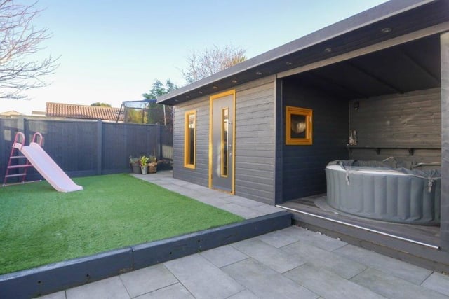 Outside to the front is parking space for three cars and the rear garden is fully landscaped with a long raised sun deck and space for outdoor furniture and alfresco dining.