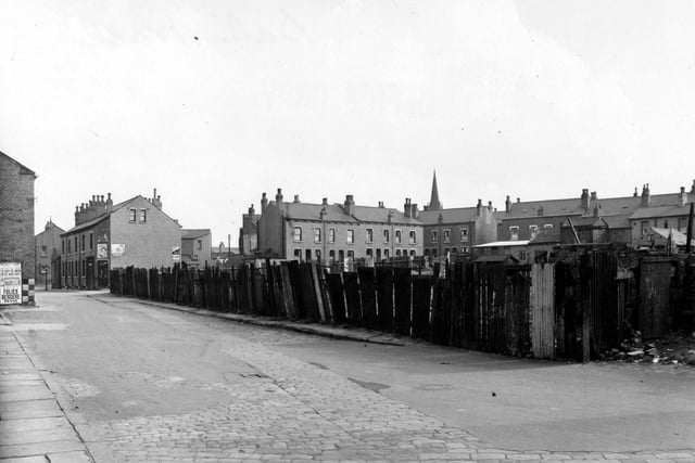 Balm Walk, looking east, south east. To the right is waste ground which is fenced off. To the left can just be seen a poster advertising the Folies Bergere Revue. Pictured in September 1951.