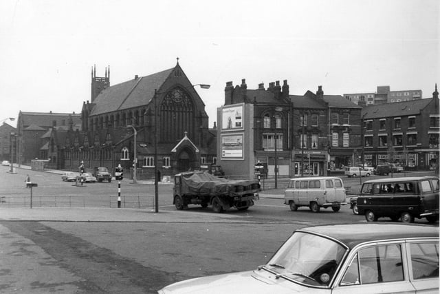 A view from Woodpecker Junction showing St. Patrick's Roman Catholic Church located in New York Road in May/June 1964. Properties from the centre to the right are in Burmantofts Street and traffic approaching the junction from the right is in York Road. Marsh Lane goes off left just below the centre of the left edge. The photograph is taken from near the Woodpecker Inn.
