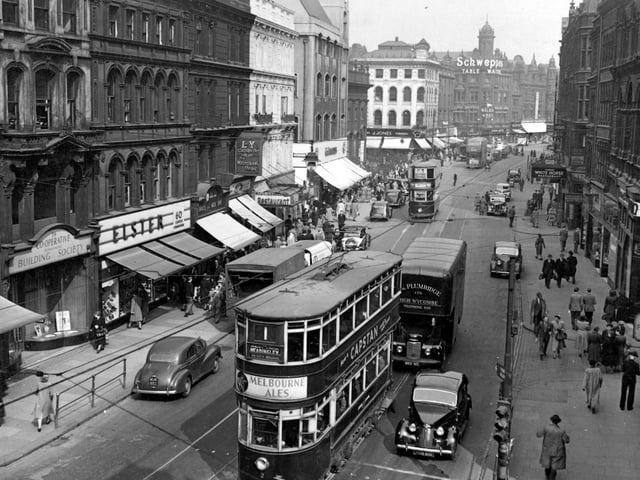 Looking east along Boar Lane in April 1951 showing shops; Elsters, J. Jones, The National Provincial Bank, the Westminster Bank and the Cooperative Building Society.