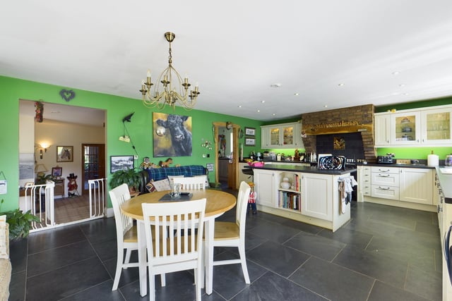 The large kitchen with diner and relaxed seating area has a central island unit, and bi-fold doors out to the gardens.