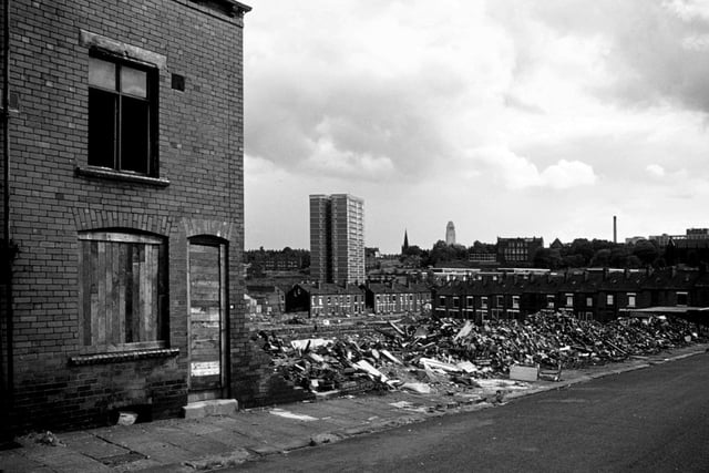 Woodhouse's Marian Terrace in the process of demolition in July 1975. No. 26 on the left is still standing so far but houses to the right of it have been reduced to rubble. With all the Marian streets behind having already been demolished (though Marian Road at right angles to it on the right remains) there is a clear view through to Holborn Towers multi-storey flats, with one of the Jubilee streets still there in front of it. The Parkinson tower of Leeds University is seen in the background.