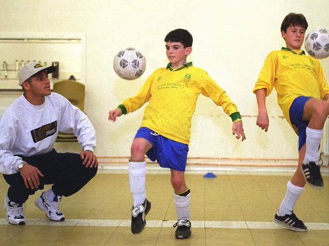 Bradford City's Brazilian star, Edhino, coaches childen, Steven Doherty (left) and Matthew Johnson and members of Jogar Brasileiro at Corpus Christi Parish Hall in November 1997.
