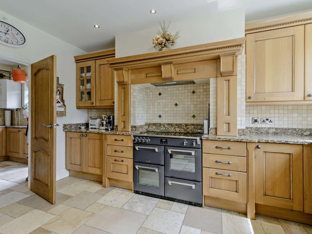 The kitchen with fitted units, granite worktops and a range cooker.